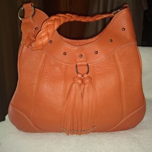Isabella Adams orange leather shoulder bag.